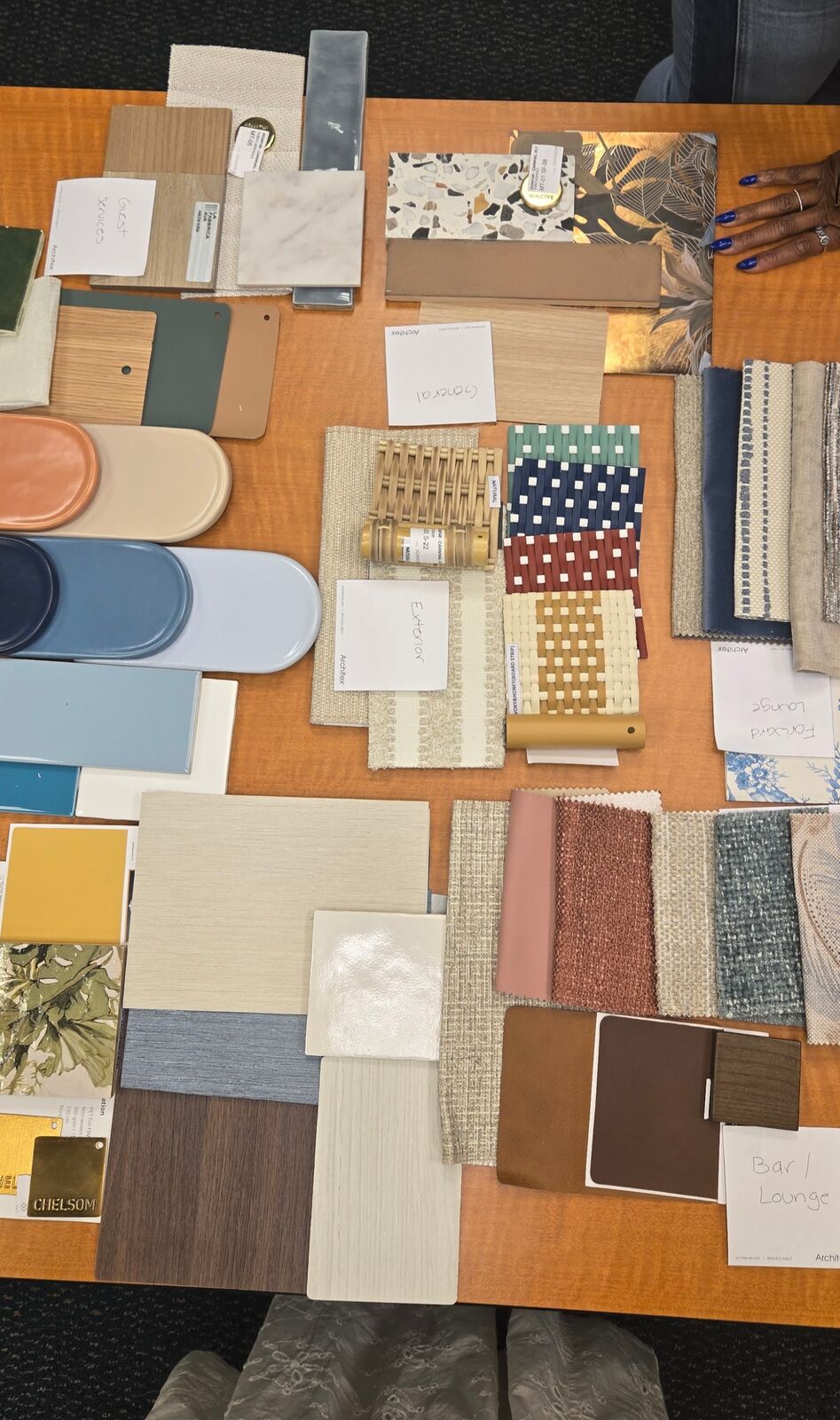 Material board with tile, wood, fabric, and finish samples laid out on a table